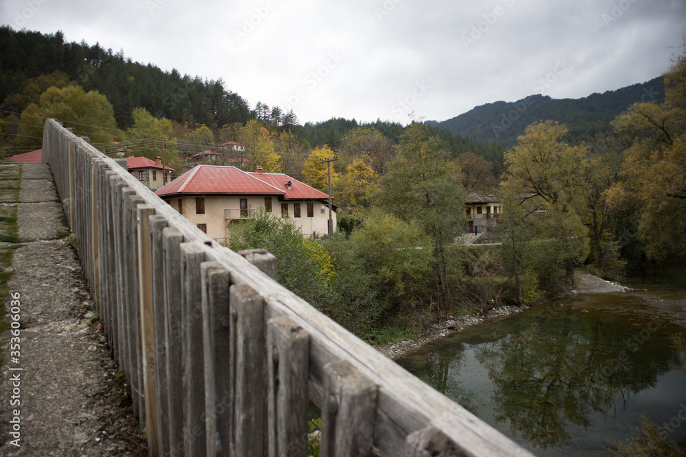 View from the pedestrian stone bridge of Vovousa, which built in 1748. The waters river Aoos and some houses appear in background. Next to Pindus National Park (Valia Calda).