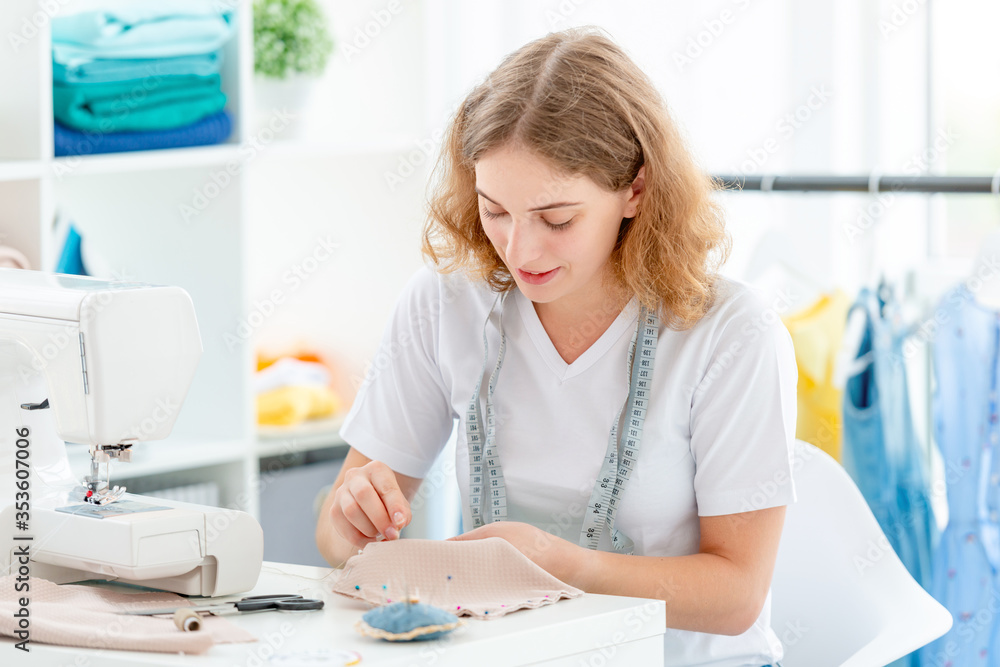 Dressmaker sewing new design by hands Dressmaker sewing new design by hands