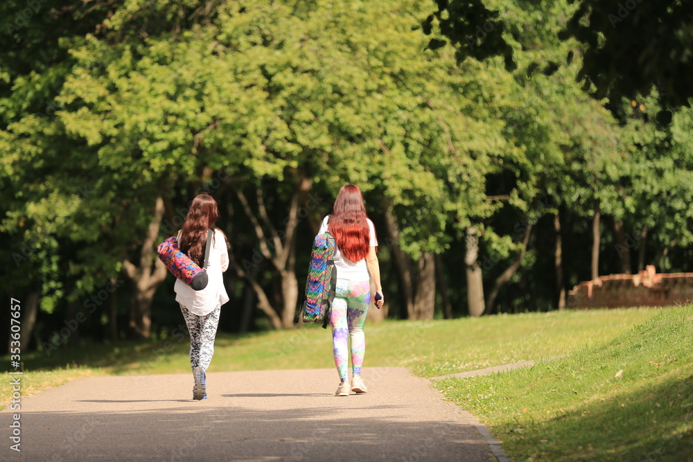 two girl walking in the park two girl walking in the park