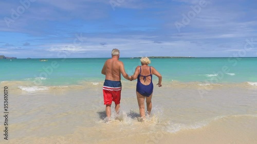 Active Senior Couple Running on Hawaiian island in 4K slow motion 60fps photo