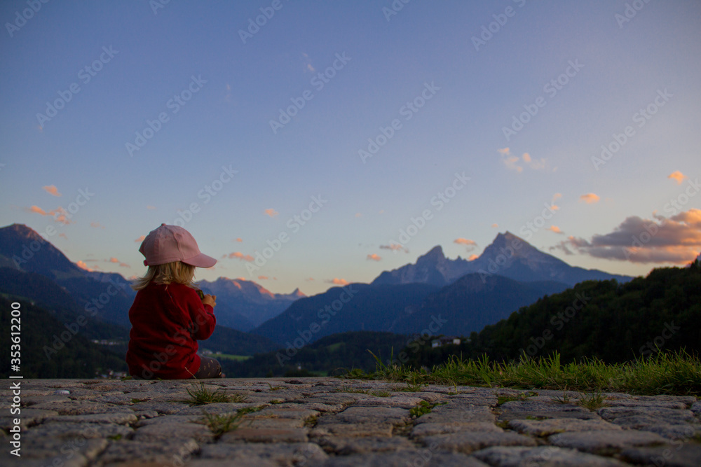 Fototapeta premium Girl in the mountains. Having a snack whit nice mountain views. 