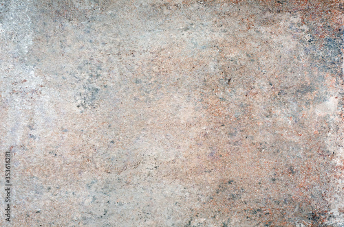 Rough stone texture with colored spots.