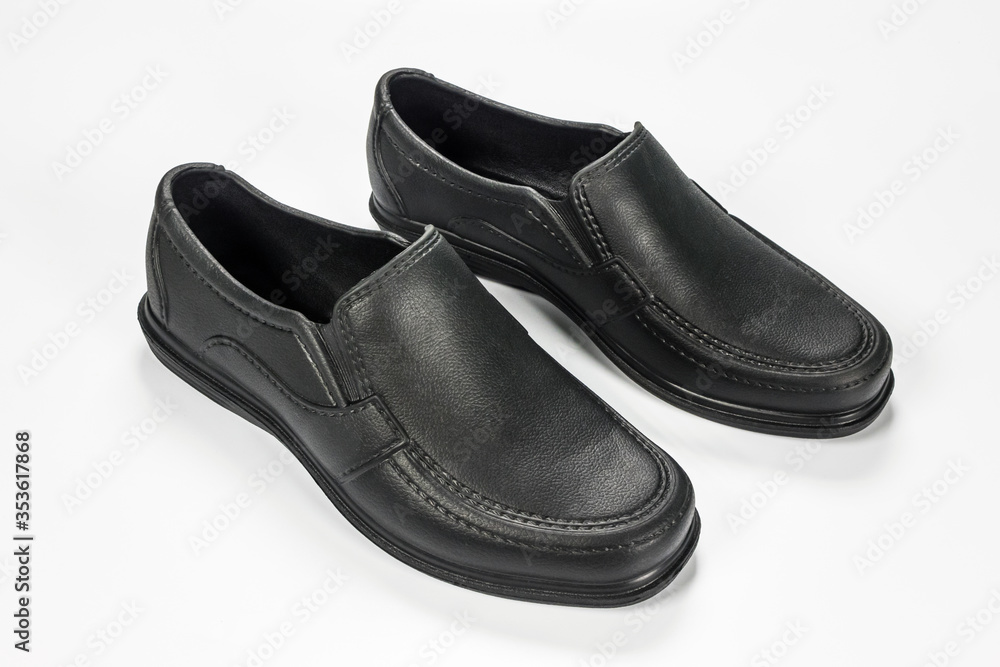 Pair of black cheap plastic shoes isolated on white background Pair of black cheap plastic shoes isolated on white background