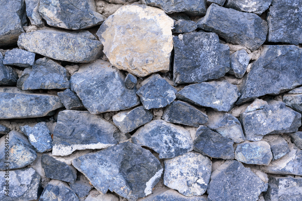 Stone wall for backdrop. Free space between blocks. Color - East Bay, Stark White. Concept of an antique fence.
