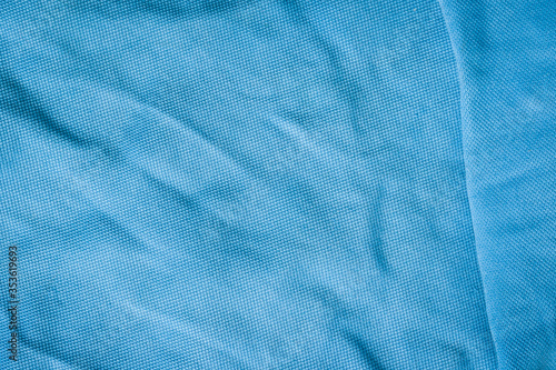 Close-up blue textile texture. Fabric material background. Blue fashion pattern.