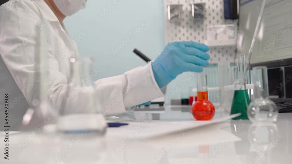 Female scientist get analyzing material on glass plate to plastic box with samples. Science, biotechnology, healthcare and chemistry concept. Female scientist get analyzing material on glass plate to plastic box with samples. Science, biotechnology, healthcare and chemistry concept.
