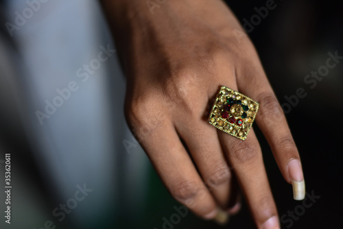 indian girl wear traditional gold and diamond ring in a hand with shallow depth of field, Indian Traditional jewelry 