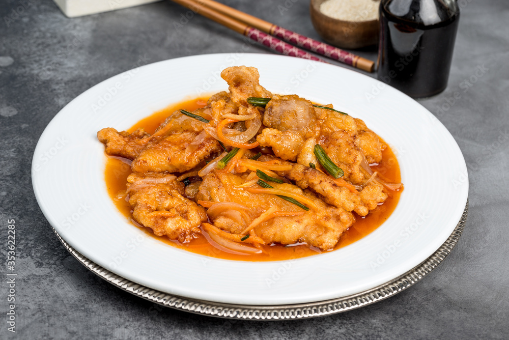 Sweet and sour pork in a white round plate