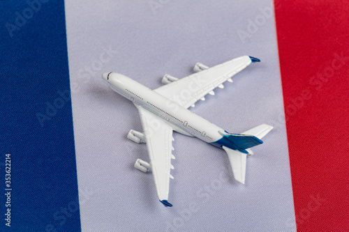 Flag of France and toy plane. Concept of air travel in France. Air travel in Europe after quarantine