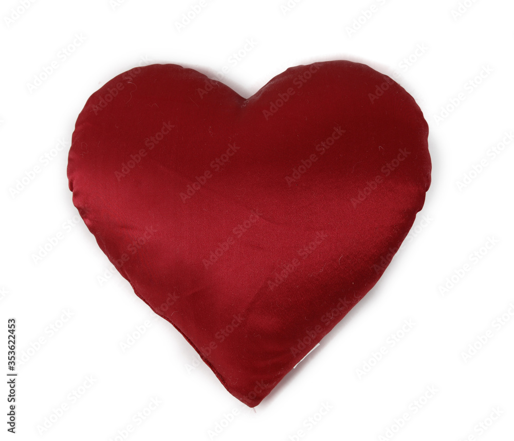 small pillow in the form of a red heart isolated on a white background