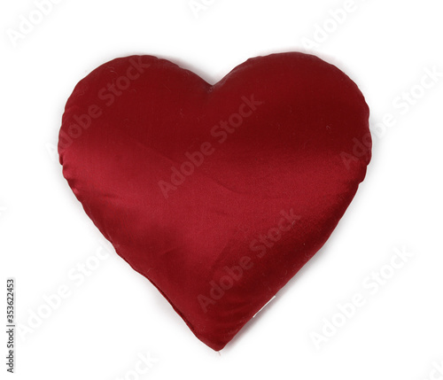 small pillow in the form of a red heart isolated on a white background