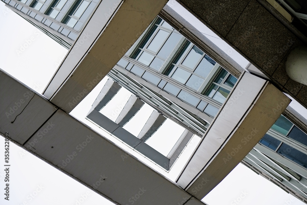 Fototapeta premium Abstract low angle view of a modern architecture building facade with panels creating a black and white structure.