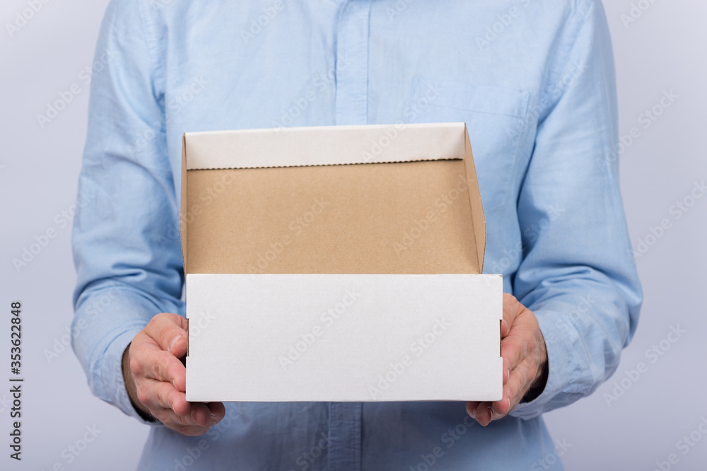 Man holding cardboard boxes. Front view. Parcel delivery home. Express delivery. Man holding cardboard boxes. Front view. Parcel delivery home. Express delivery.