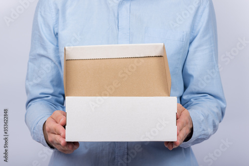 Man holding cardboard boxes. Front view. Parcel delivery home. Express delivery. © somemeans