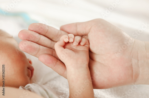 close up baby Hand on the hand of mother
