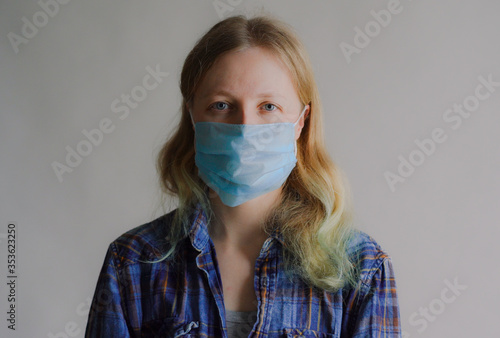 protection against coronavirus. woman puts a mask on her face.