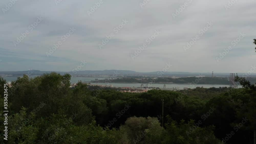 Aerial Reveal Shot of the City of Lisbon through a Forest, in Portugal Aerial Reveal Shot of the City of Lisbon through a Forest, in Portugal