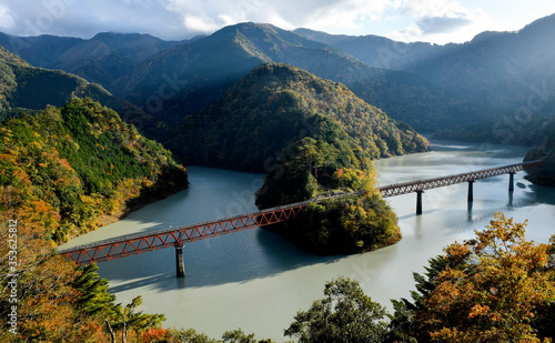 The Oigawa railway station for sightseeing around dam with hidden station during Autumn leaves , in Senzu line, Shizuoka, Japan photo