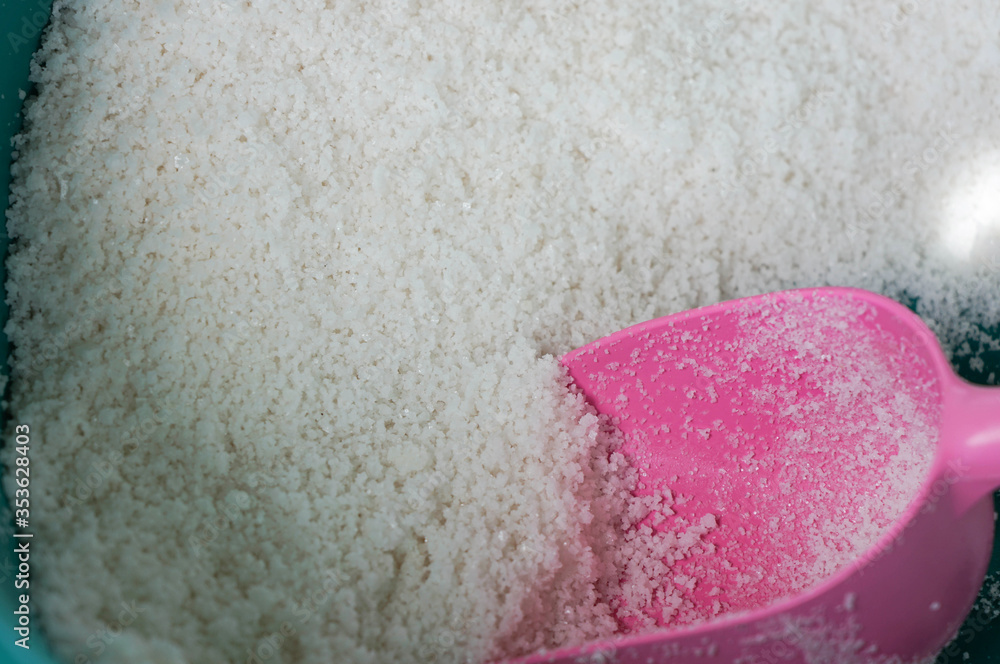Fototapeta premium Flower of Salt white color in bowl and plastic spoon the raw material and ingredient for cook from sea