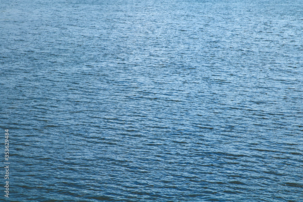 Obraz premium Flat calm blue water surface 