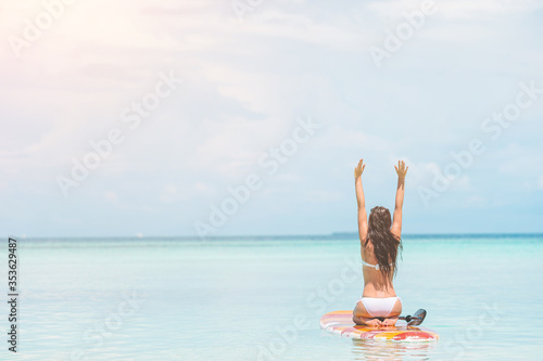 Woman surfing in the sea on vacation