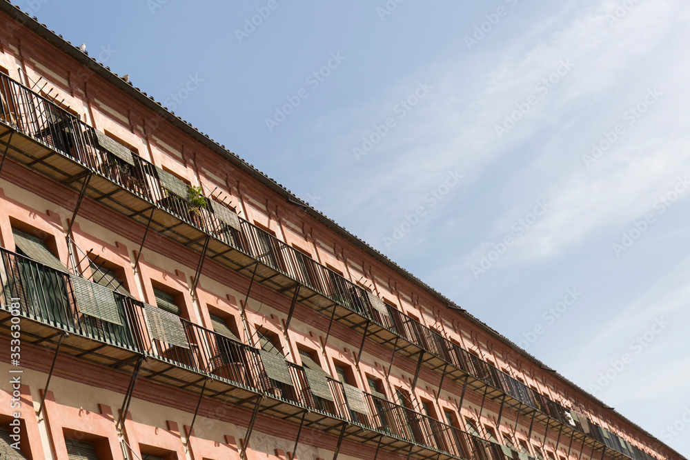 facade of a building with multiple identical windows creating the perspective of oblique lines on the horizon facade of a building with multiple identical windows creating the perspective of oblique lines on the horizon
