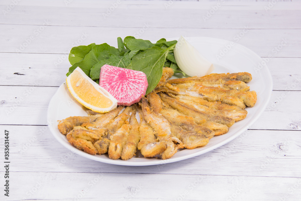 sea food plate with fried fish, lemon and onion sea food plate with fried fish, lemon and onion