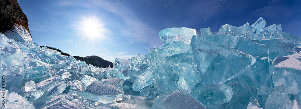 Siberian Baikal Lake in the winter. Panoramic view of ice hummocks near Cape Khoboy of Olkhon Island on a sunny frosty day. Winter travel. Natural background. Unusual landscape Siberian Baikal Lake in the winter. Panoramic view of ice hummocks near Cape Khoboy of Olkhon Island on a sunny frosty day. Winter travel. Natural background. Unusual landscape