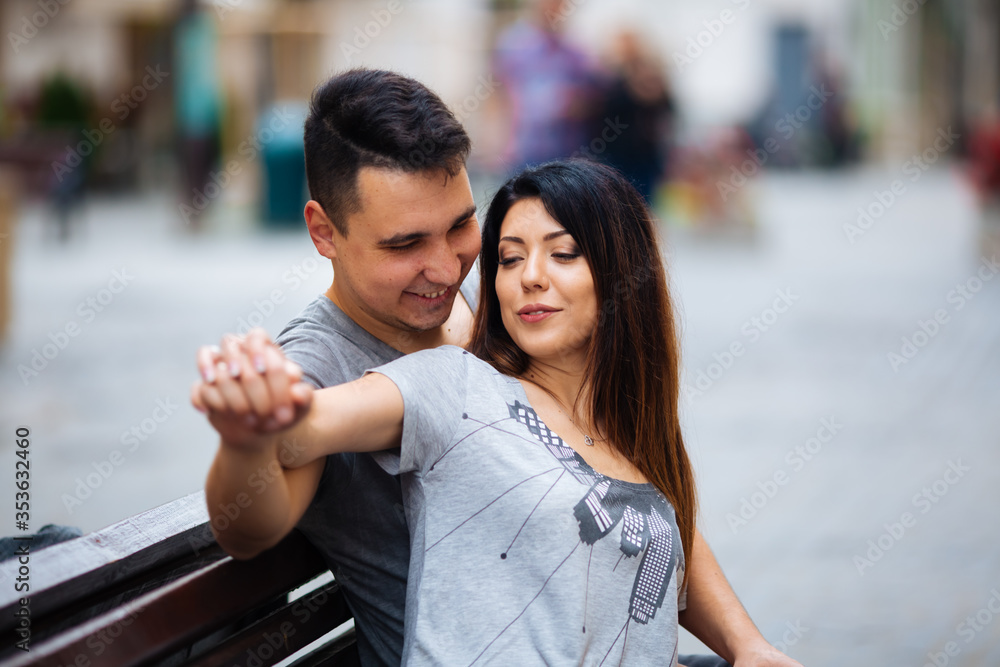 A couple in love slowly walks the streets of the city on a cool autumn morning.