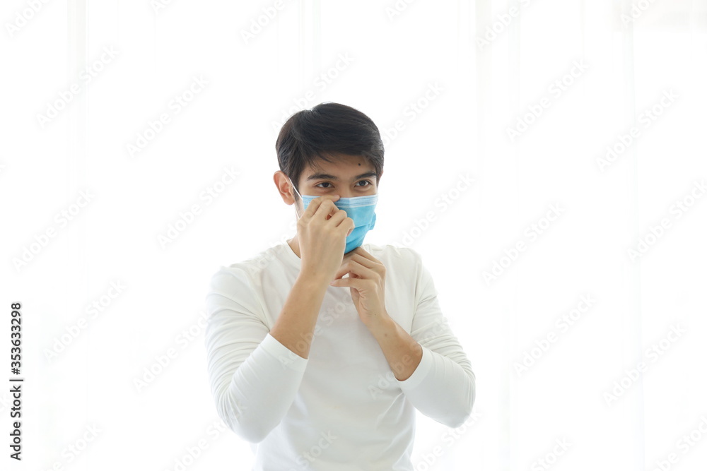 Portrait of a young man wearing a medical mask on white background. Portrait of a young man wearing a medical mask on white background.