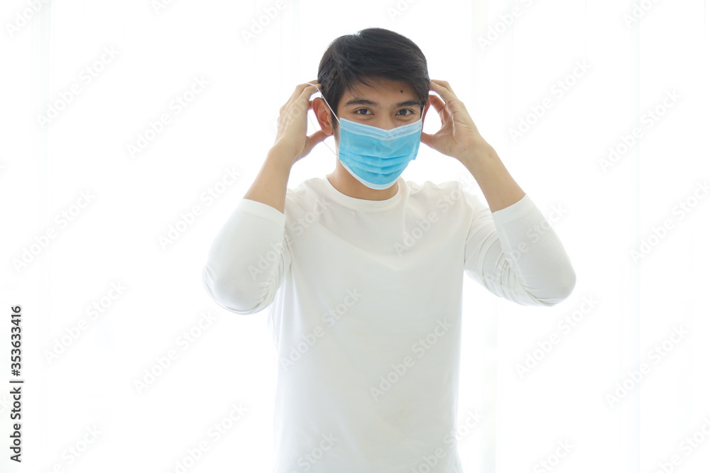 Portrait of a young man wearing a medical mask on white background. Portrait of a young man wearing a medical mask on white background.