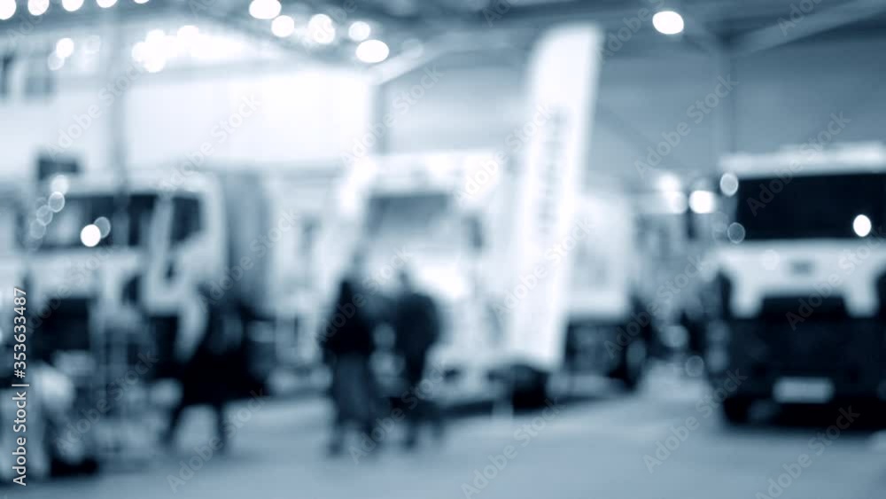 Blurred Background Many cars trucks lorry inside the exhibition pavilion Blurred Background Many cars trucks lorry inside the exhibition pavilion