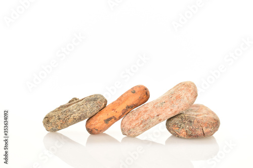 Organic, natural cocoa beans, close-up, on a white background.