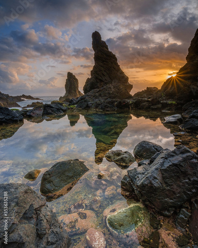 Beautiful beach in gunung kidul, indonesia. Sunset at the beautiful beach with rocks in the foreground.