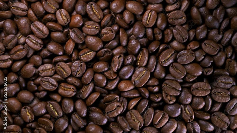 Roasted coffee bean. Fragrant coffee beans scrolls slowly around the camera. Slow Motion Close Up of Whole Roasted Coffee Beans. Roasted coffee bean. Fragrant coffee beans scrolls slowly around the camera. Slow Motion Close Up of Whole Roasted Coffee Beans.