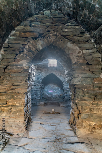 The view of interior in old stone ancient caravanserai in Tash-Rabat in Kyrgyzstan photo