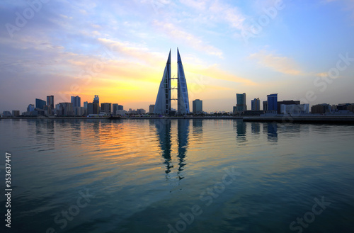 MANAMA, BAHRAIN - FEBRUARY 23: The Bahrain World Trade Center during sunrise, a twin tower complex is the first skyscraper in the world to have wind turbines, February 23, 2018, Manama, Bahrain