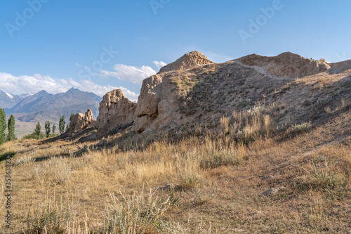 Fototapeta The view of old ancient ruined city Koshoy Korgon and the clay city wall in Kyrg