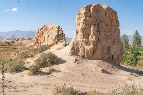 Slika na platnu The view of old ancient ruined city Koshoy Korgon and the clay city wall in Kyrg