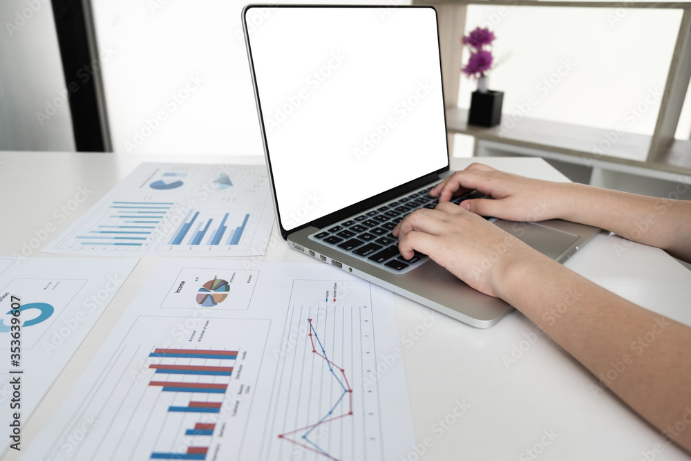 Businessman is working with computer notebook for analyze marketing strategy from the sell performance graph in the office room. Businessman is working with computer notebook for analyze marketing strategy from the sell performance graph in the office room.