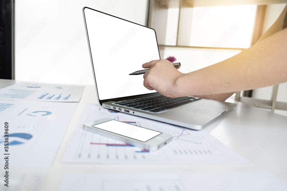 Business women is working with computer notebook for analyze marketing strategy from the sell performance graph in the office room. Business women is working with computer notebook for analyze marketing strategy from the sell performance graph in the office room.