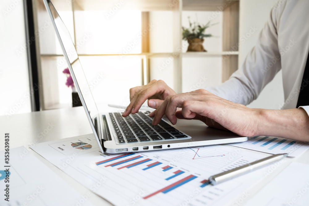 Businessman is working with computer notebook for analyze marketing strategy from the sell performance graph in the office room. Businessman is working with computer notebook for analyze marketing strategy from the sell performance graph in the office room.