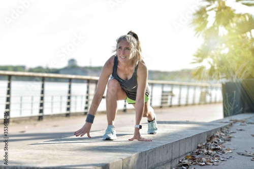 young woman doing her stretching after her jogging