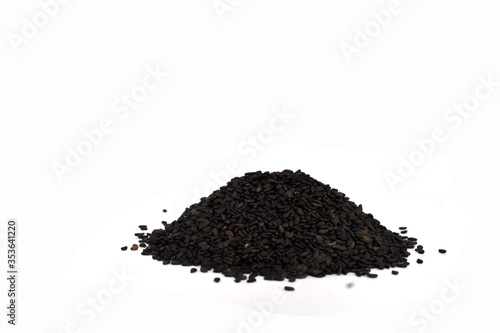 Pile of black sesame seeds isolated on white background. Clipping path