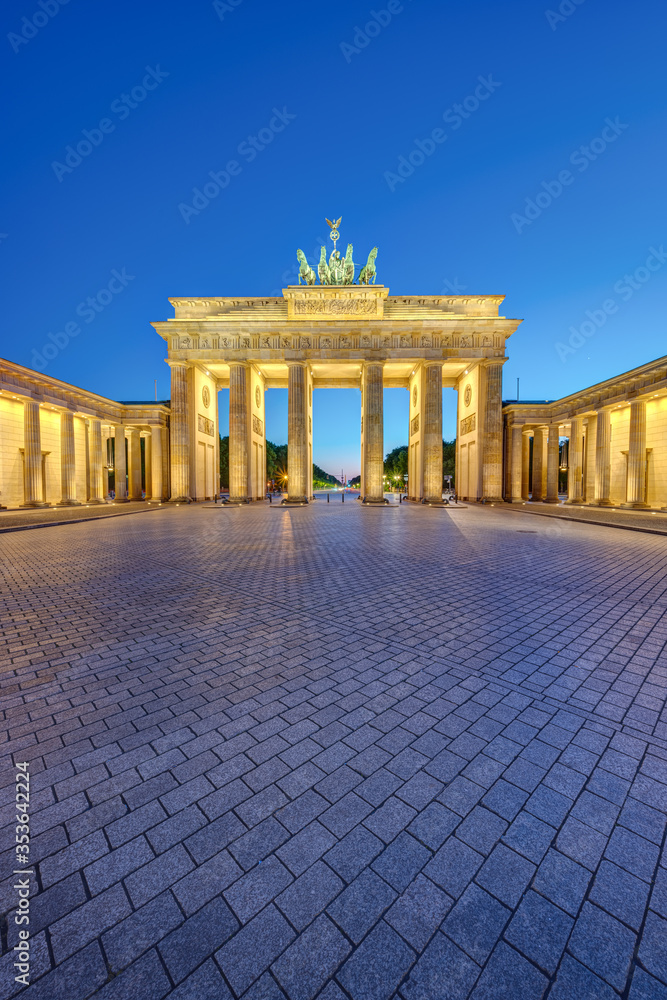 The illuminated Brandenburg Gate in Berlin at dusk with no people