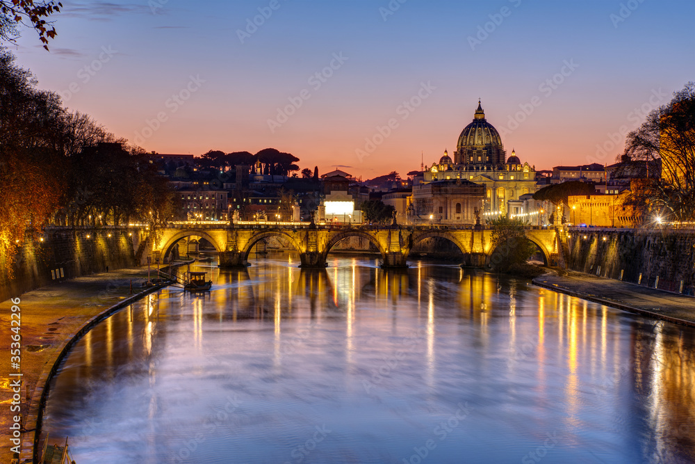 Sunset over the St. Peters Basilica and the river Tiber in Rome