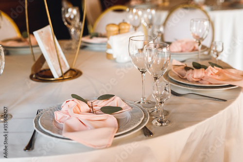 Festive table setting with empty wine glasses photo