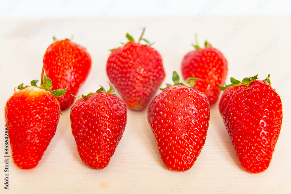Ripe strawberries on wooden surface Ripe strawberries on wooden surface