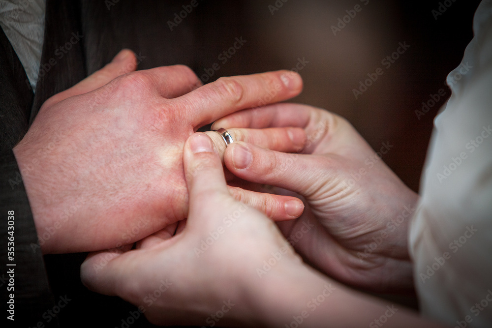 An unrecognizable bride and groom exchanging of the Wedding Rings in church during the christian wedding ceremony An unrecognizable bride and groom exchanging of the Wedding Rings in church during the christian wedding ceremony