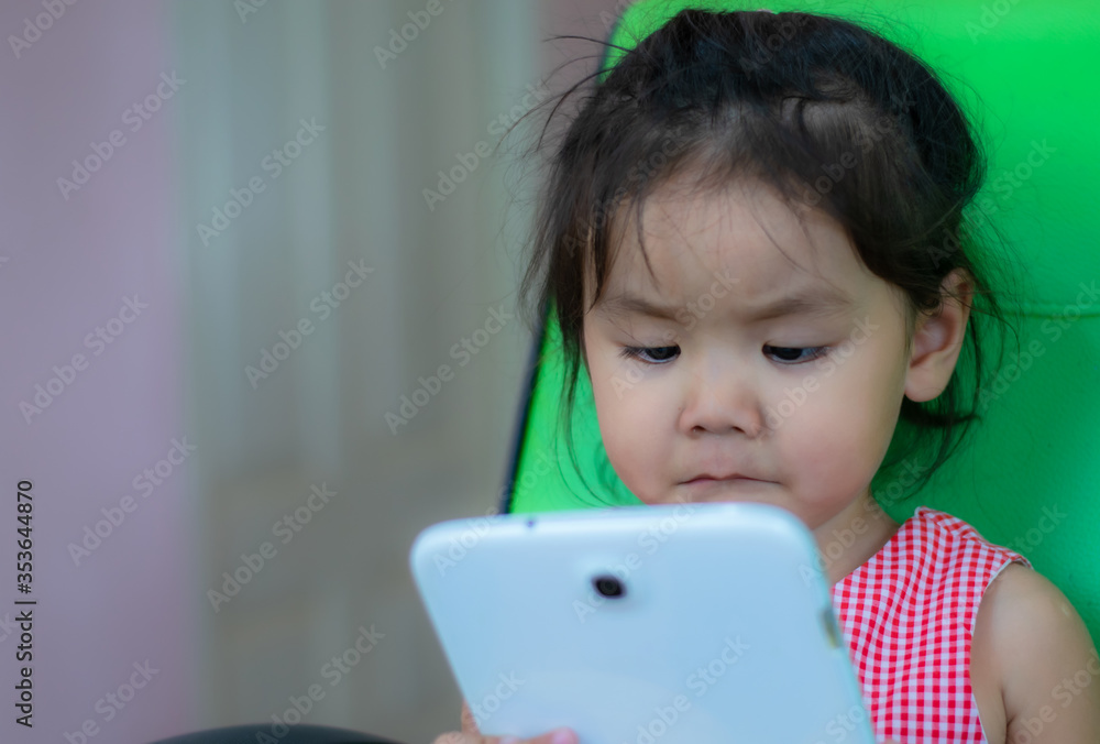 Kindergarten Asian girls playing tablet with fun